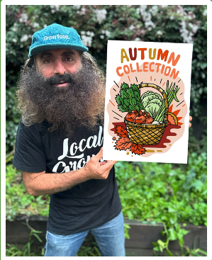 Man holding autumn produce collection poster.